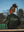 Person holding a tennis racket on a tennis court with 'Dreamer' jacket